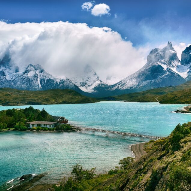 lake near snow-covered mountain during daytime